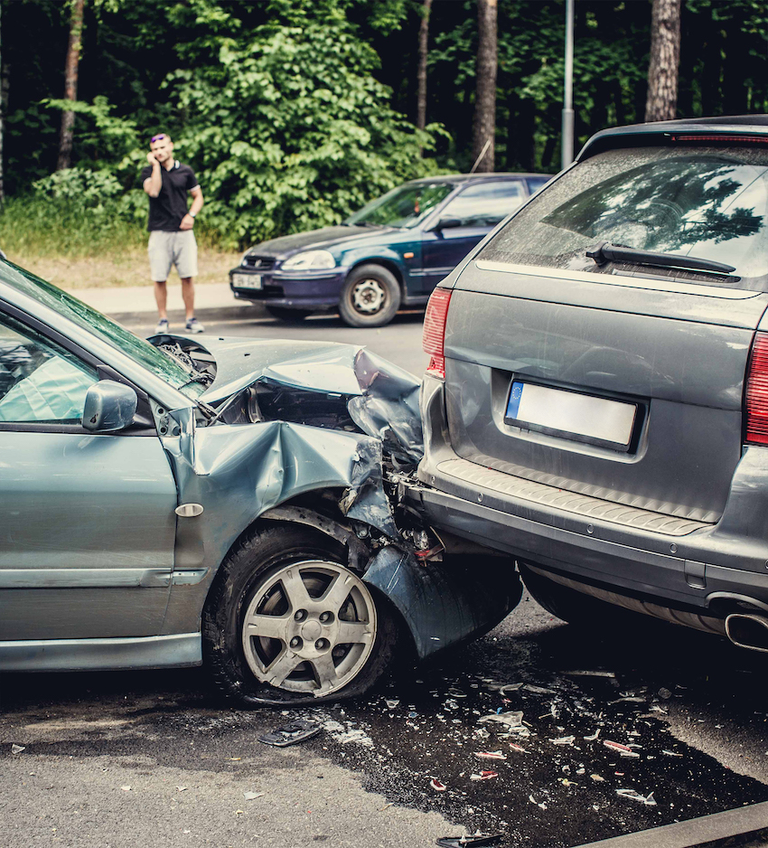 Close up smached cars on a road. Image of a auto accident involving two cars.